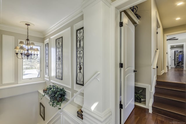 interior space featuring dark wood-style floors, a chandelier, stairs, and crown molding