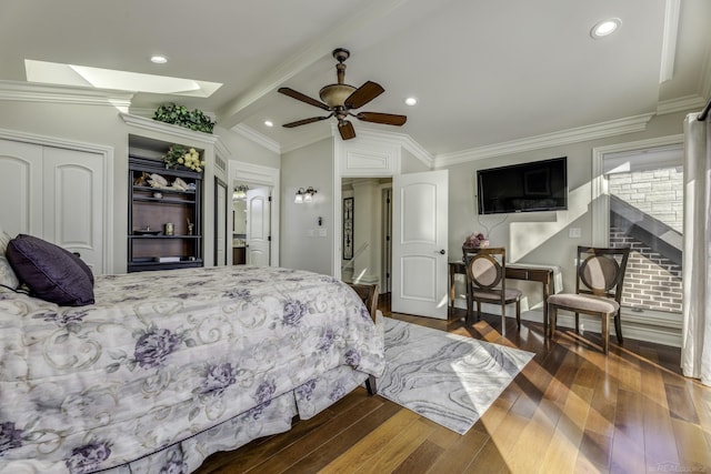 bedroom featuring lofted ceiling with skylight, recessed lighting, ornamental molding, and wood finished floors