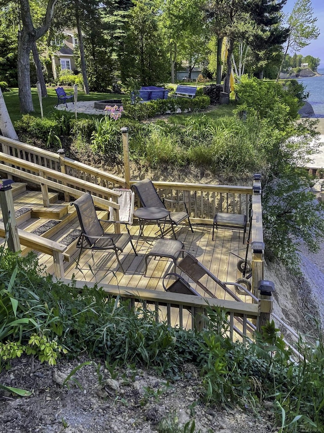 view of property's community featuring a deck with water view