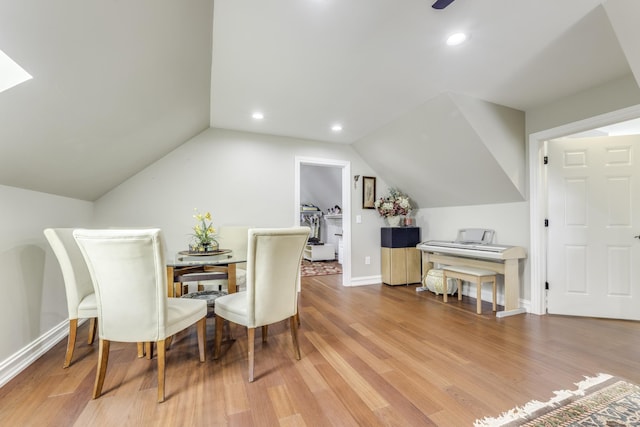 dining area with vaulted ceiling, baseboards, wood finished floors, and recessed lighting