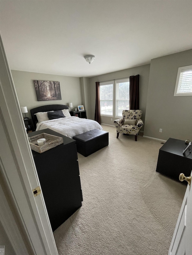 carpeted bedroom featuring baseboards