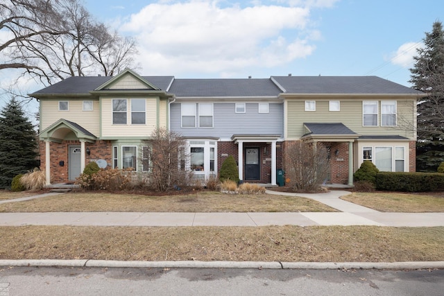 view of property featuring brick siding