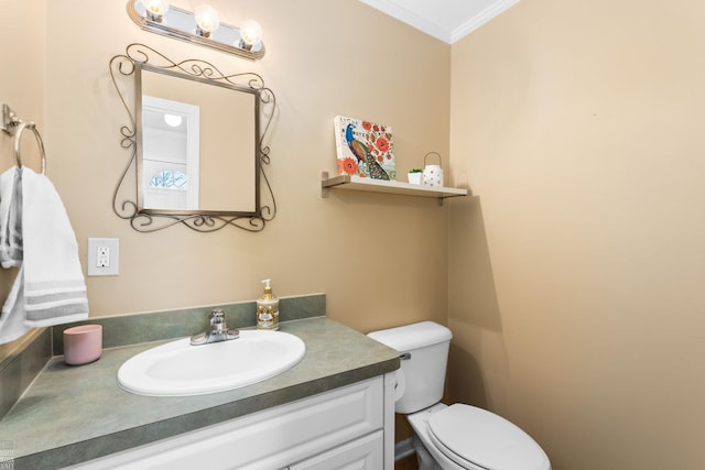 half bath featuring toilet, ornamental molding, and vanity