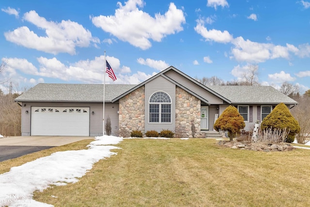 ranch-style house featuring a shingled roof, an attached garage, a front yard, stone siding, and driveway