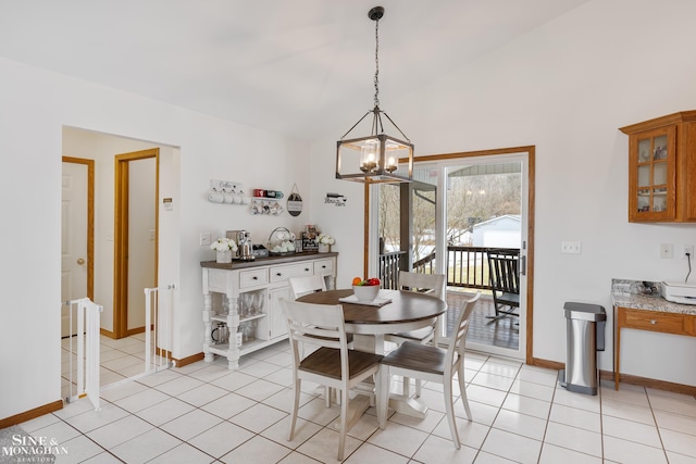 dining area featuring lofted ceiling, baseboards, and light tile patterned floors