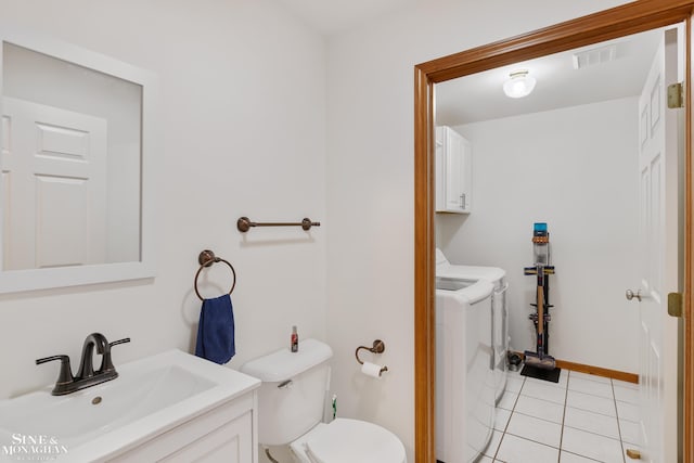 half bath with toilet, vanity, visible vents, tile patterned floors, and washing machine and clothes dryer