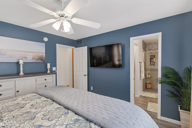 bedroom featuring baseboards, visible vents, ceiling fan, wood finished floors, and ensuite bathroom