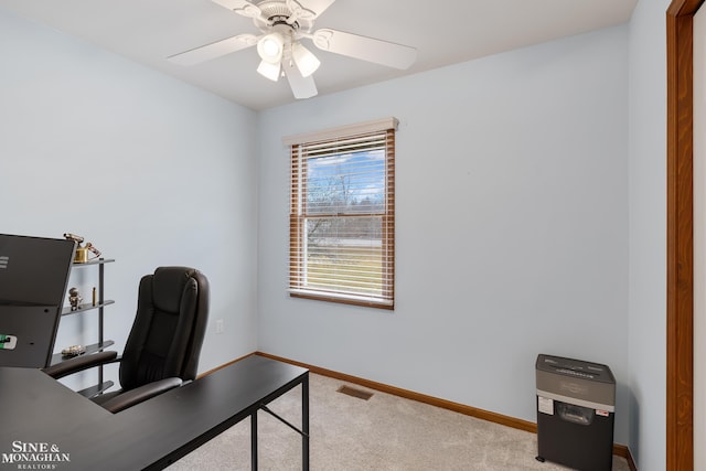 office featuring a ceiling fan, carpet, visible vents, and baseboards