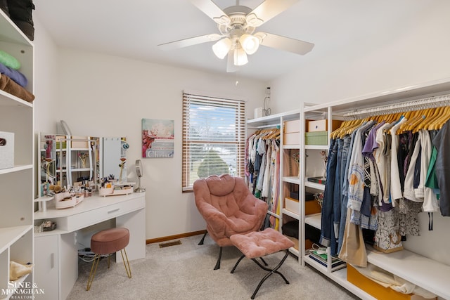 interior space with a ceiling fan, visible vents, baseboards, and carpet flooring