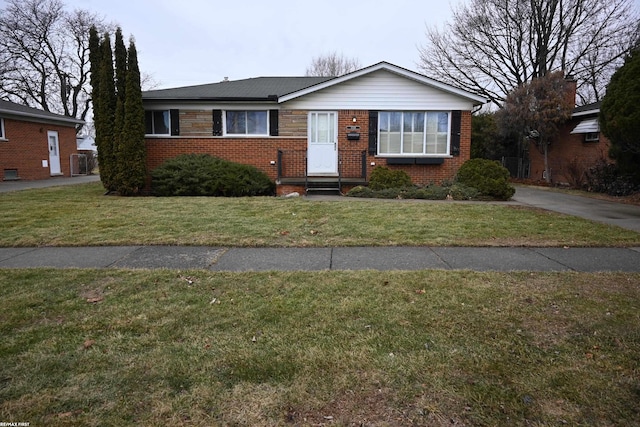 view of front facade featuring a front yard and brick siding