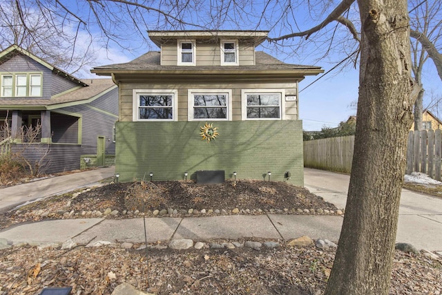 view of front of property with fence and brick siding