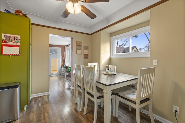 dining area with ceiling fan, baseboards, and wood finished floors