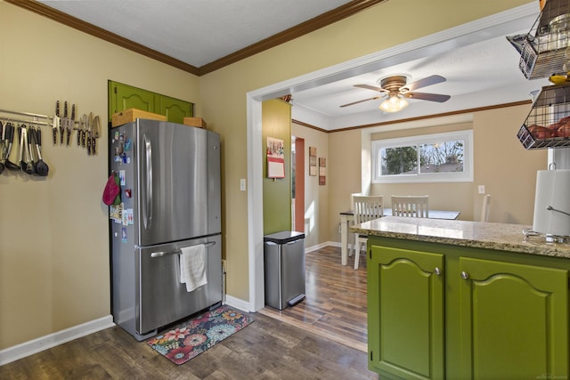 kitchen with ornamental molding, freestanding refrigerator, dark wood-style flooring, and green cabinets