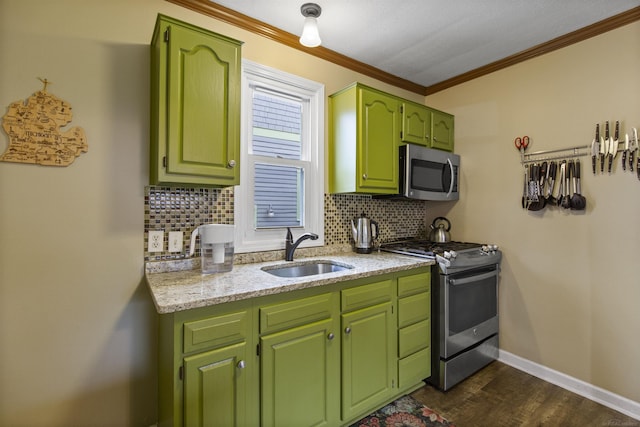 kitchen with baseboards, appliances with stainless steel finishes, a sink, and tasteful backsplash