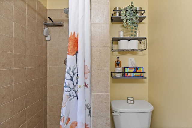 bathroom with tiled shower and toilet