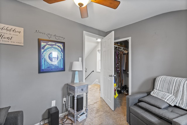 living area featuring carpet floors and a ceiling fan