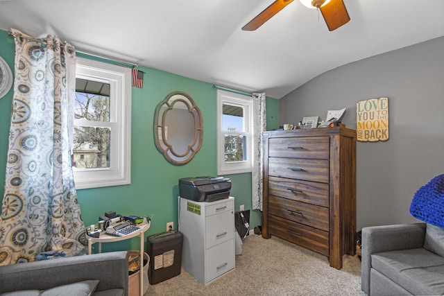 interior space featuring lofted ceiling, ceiling fan, and light carpet