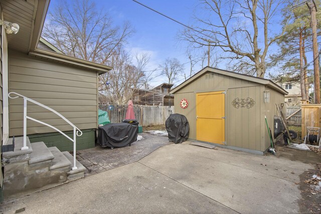 exterior space with an outbuilding, a shed, grilling area, and a fenced backyard