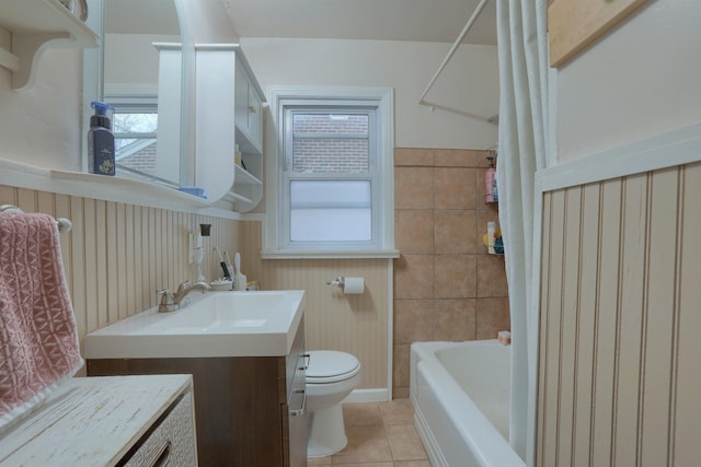 bathroom featuring toilet, vanity, a wealth of natural light, and tile patterned floors