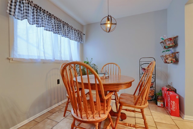 dining room featuring baseboards and light tile patterned floors