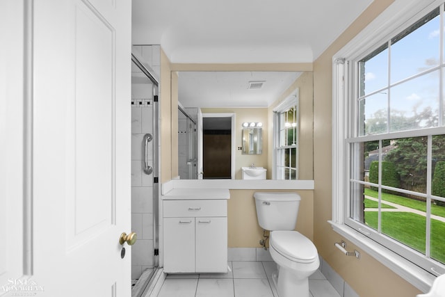 bathroom featuring toilet, a stall shower, plenty of natural light, and vanity