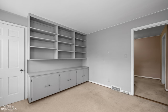 unfurnished bedroom with light carpet, visible vents, and baseboards