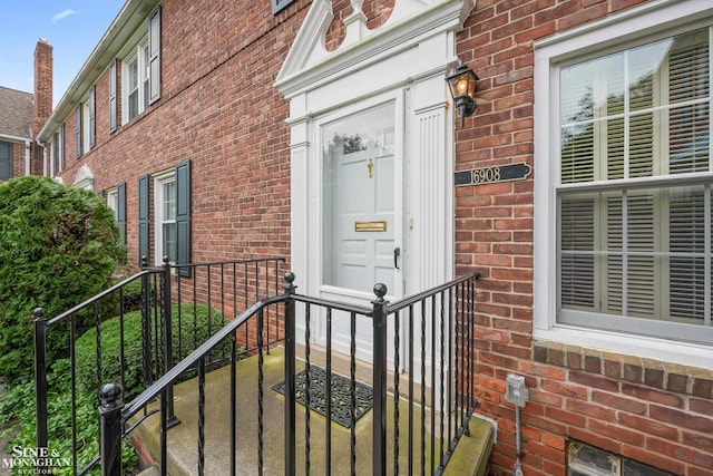 property entrance featuring brick siding