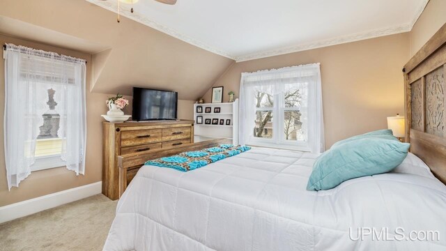 bedroom with ceiling fan, baseboards, vaulted ceiling, and carpet flooring