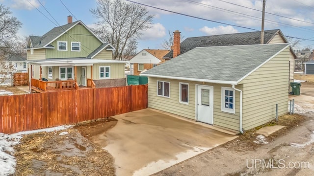 view of front of property with a fenced front yard and a chimney