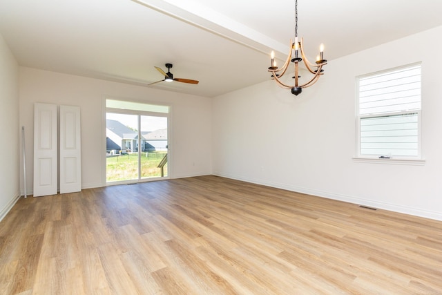 unfurnished room with visible vents, light wood-style flooring, baseboards, and ceiling fan with notable chandelier