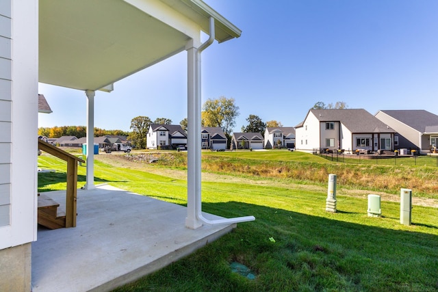 view of yard featuring a residential view and a patio