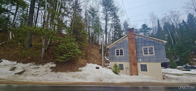 view of property exterior featuring a chimney