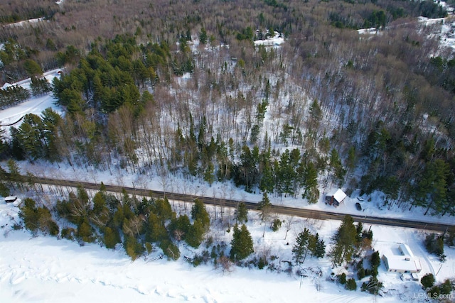 snowy aerial view with a forest view