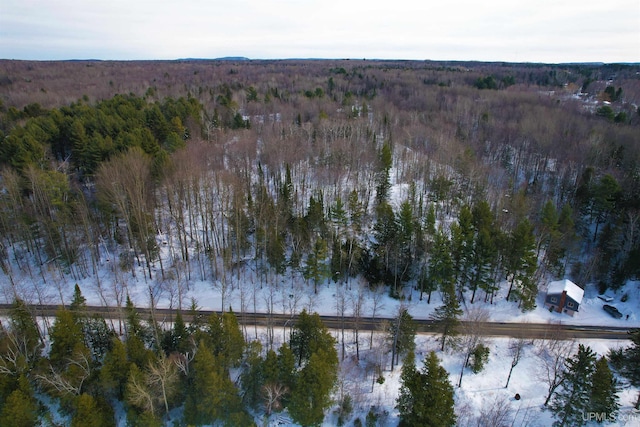 birds eye view of property with a view of trees