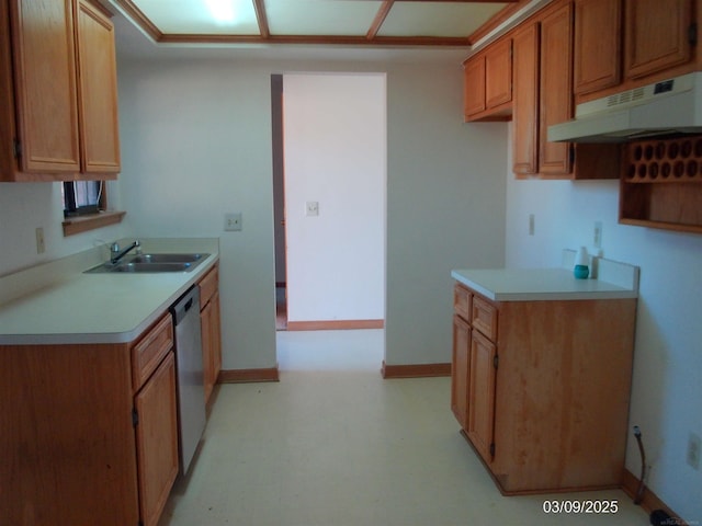 kitchen featuring under cabinet range hood, a sink, light countertops, baseboards, and dishwasher