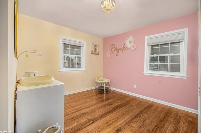 interior space featuring baseboards and wood finished floors