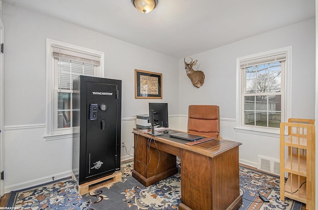 home office with visible vents, baseboards, and wood finished floors