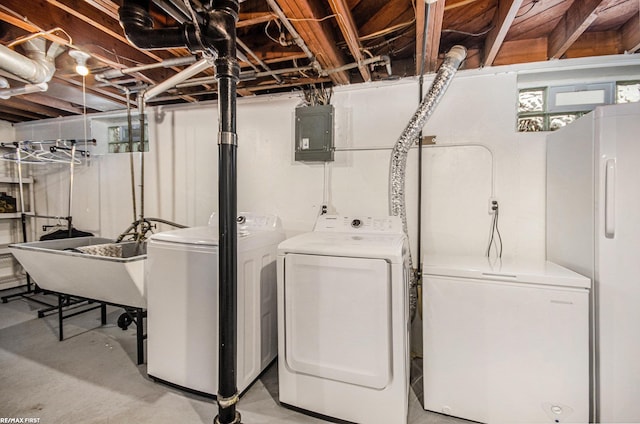 clothes washing area with laundry area, electric panel, independent washer and dryer, and a sink