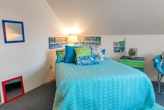 bedroom featuring lofted ceiling and carpet