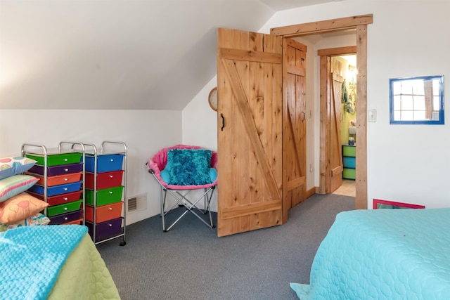 carpeted bedroom featuring lofted ceiling and visible vents