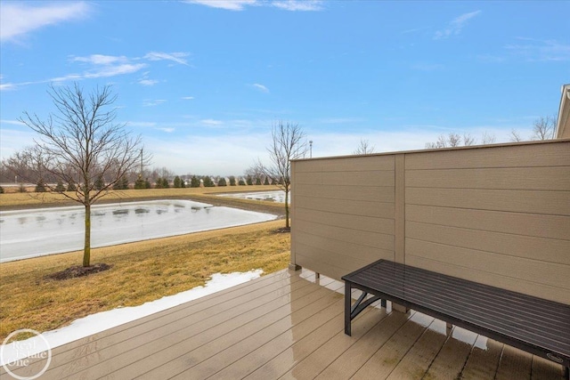 wooden deck featuring a yard and a water view