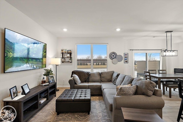 living area featuring recessed lighting, a healthy amount of sunlight, and wood finished floors