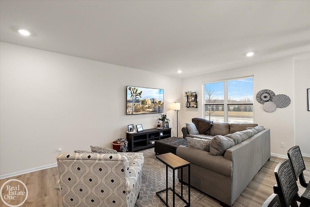 living area with light wood-type flooring, baseboards, and recessed lighting