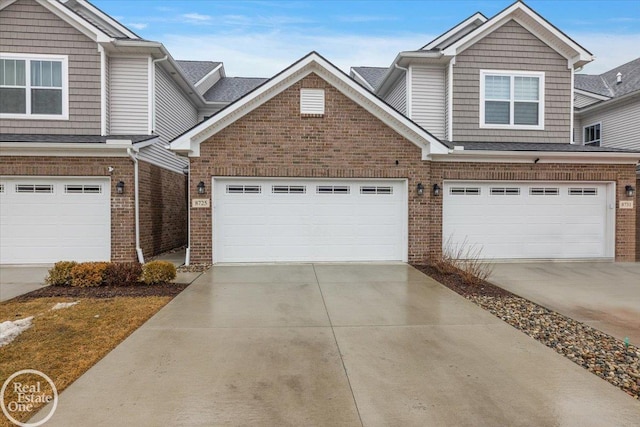 view of front of property featuring driveway and brick siding