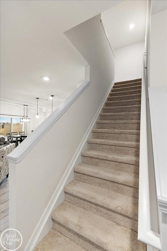 staircase with recessed lighting, carpet, and baseboards