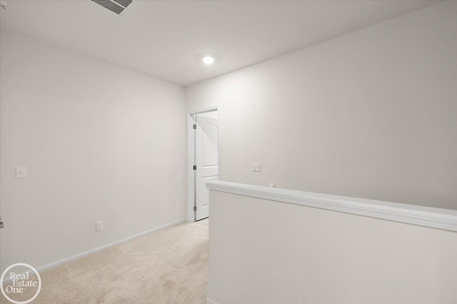 hall featuring recessed lighting, light colored carpet, visible vents, and baseboards