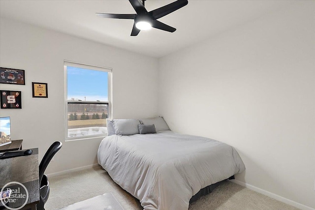 carpeted bedroom featuring a ceiling fan and baseboards