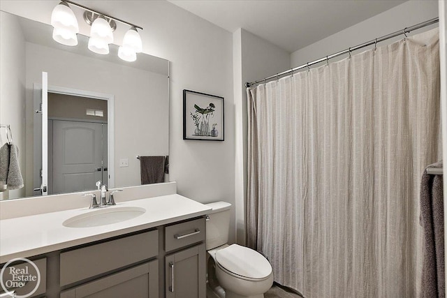 full bath featuring toilet and vanity