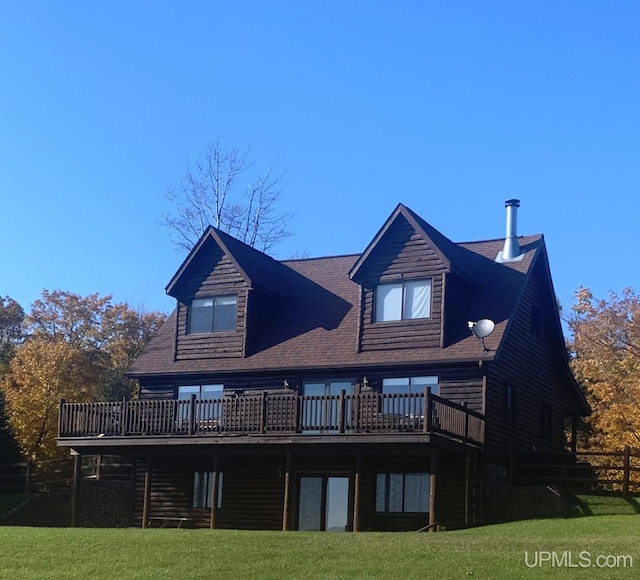 back of house featuring a lawn and a wooden deck