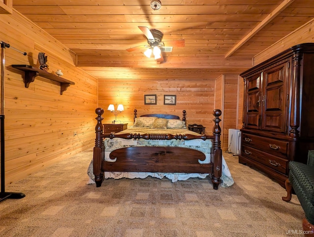 bedroom featuring light carpet, wood walls, wood ceiling, and radiator